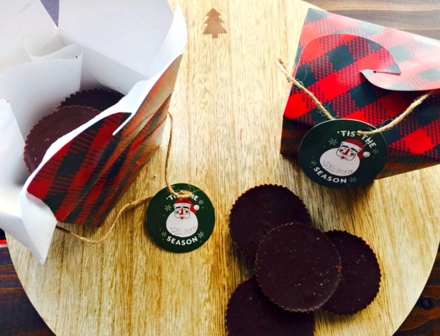 Peanut butter chocolate fudge next to green and red plaid treat boxes