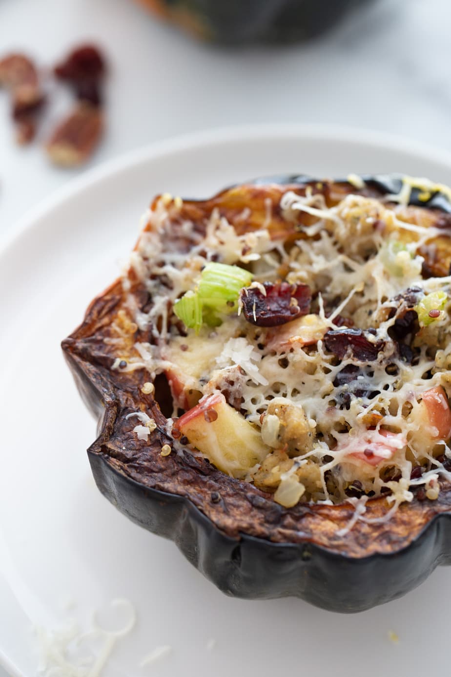 Acorn squash stuffed with sausage, quinoa, apple, celery, and cranberries then topped with shredded cheese and cooked in the Air Fryer.