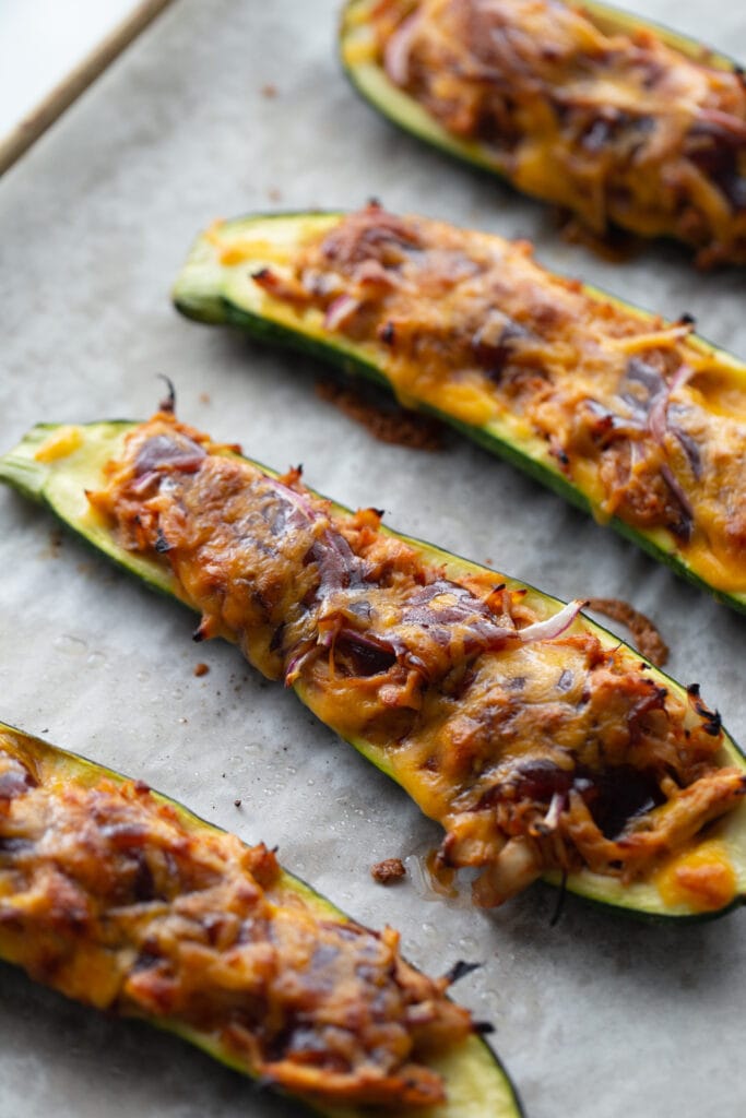 BBQ chicken stuffed zucchini boats straight from the oven, ready for garnish