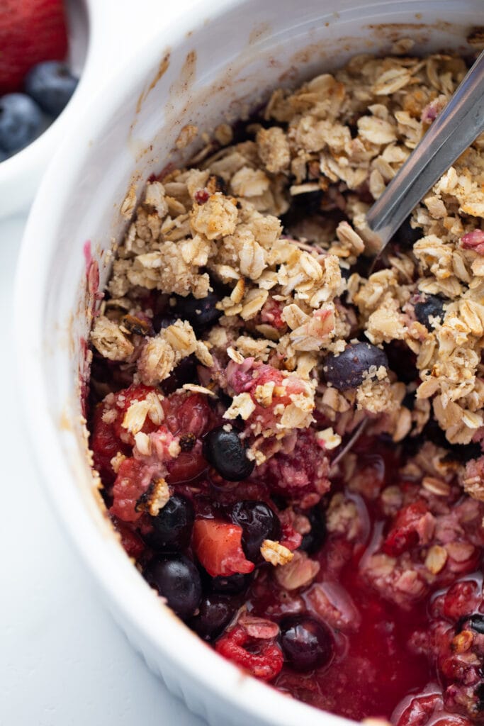 Large casserole dish of mixed berry crisp topped with gluten free oats, made in the Instant Pot.