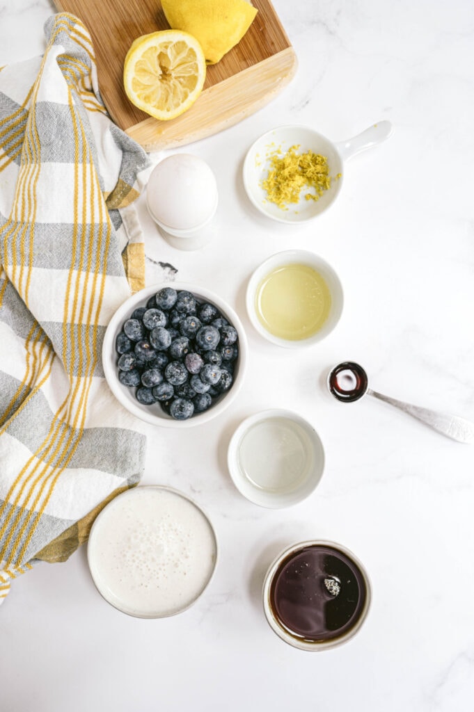 Ingredients for Lemon Blueberry Bread on a white marble table 