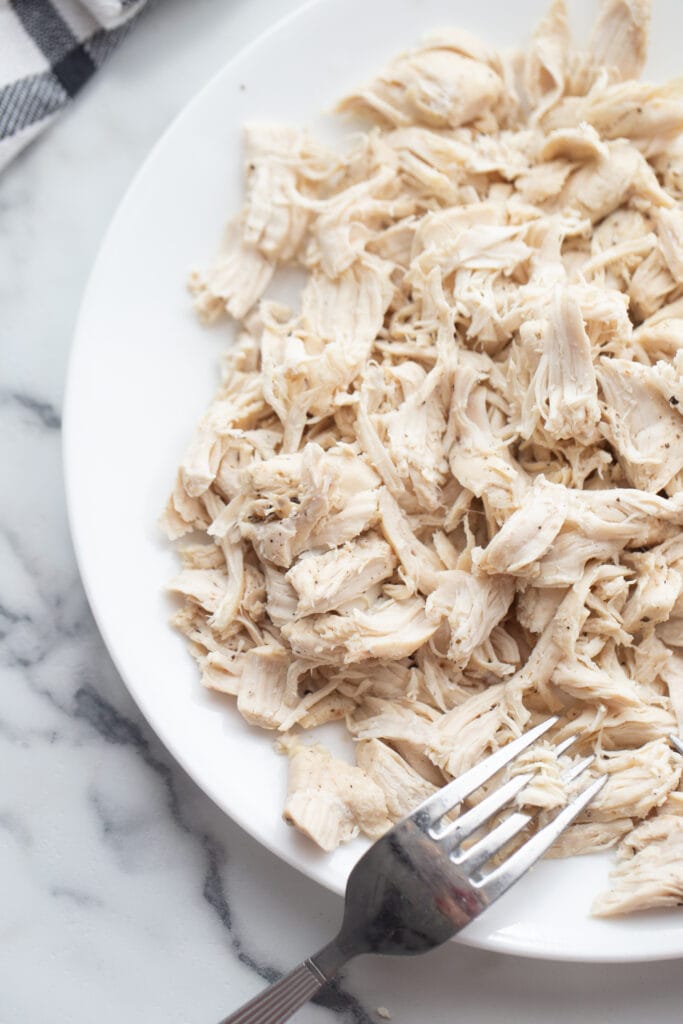 Shredded chicken breast on a plate. 