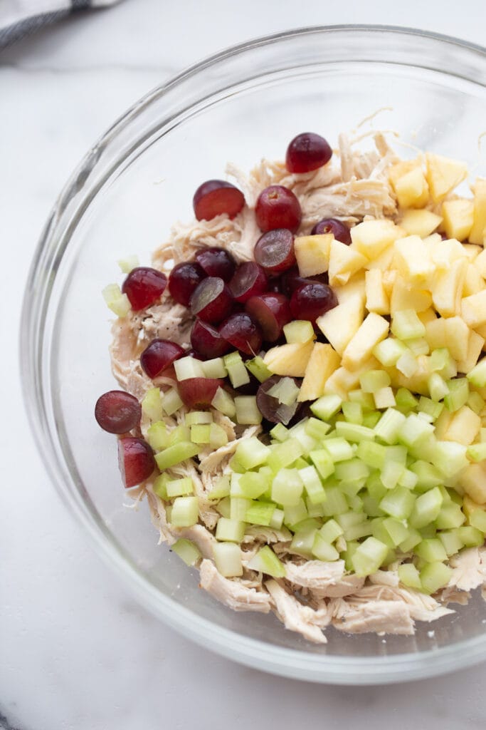 Shredded chicken salad topped with grapes, celery, and diced apples. 