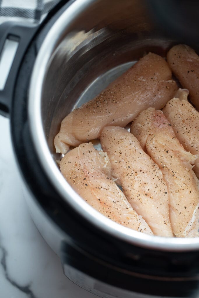 Raw chicken inside an instant pot. 