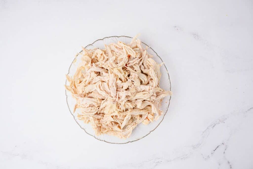 Shredded Chicken in a Bowl on a white background.
