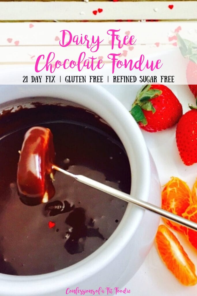 Close up photo of chocolate fondue recipe with a mandarin orange dipped into the white bowl. Extra fruit is off to the side. There is a text overlay- Dairy Free Chocolate Fondue | 21 Day Fix | Gluten Free | Refined Sugar Free | Confessions of a Fit Foodie