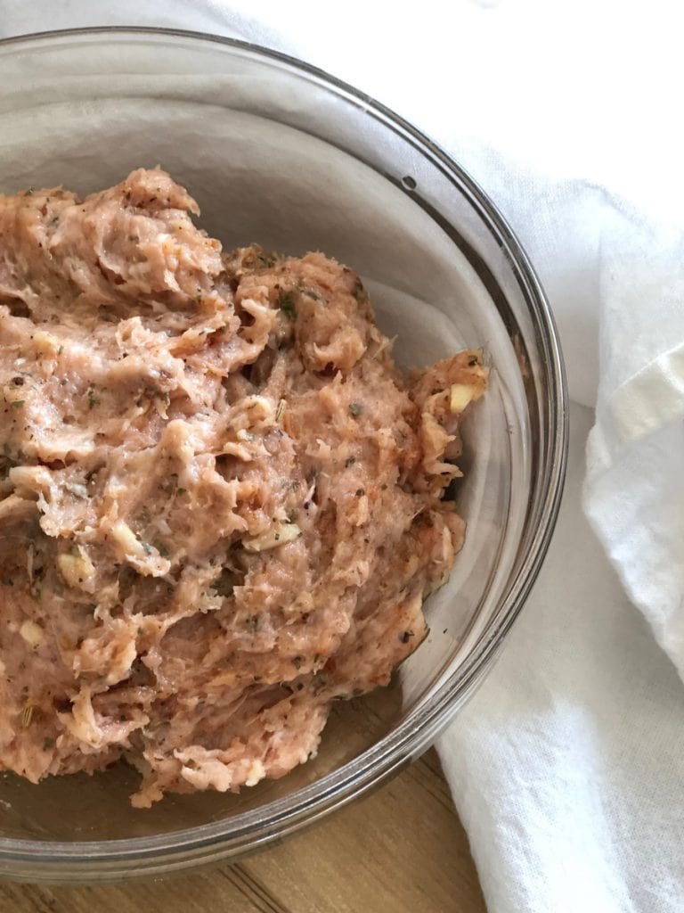 Raw Chicken in a bowl with homemade Italian Sausage Seasonings