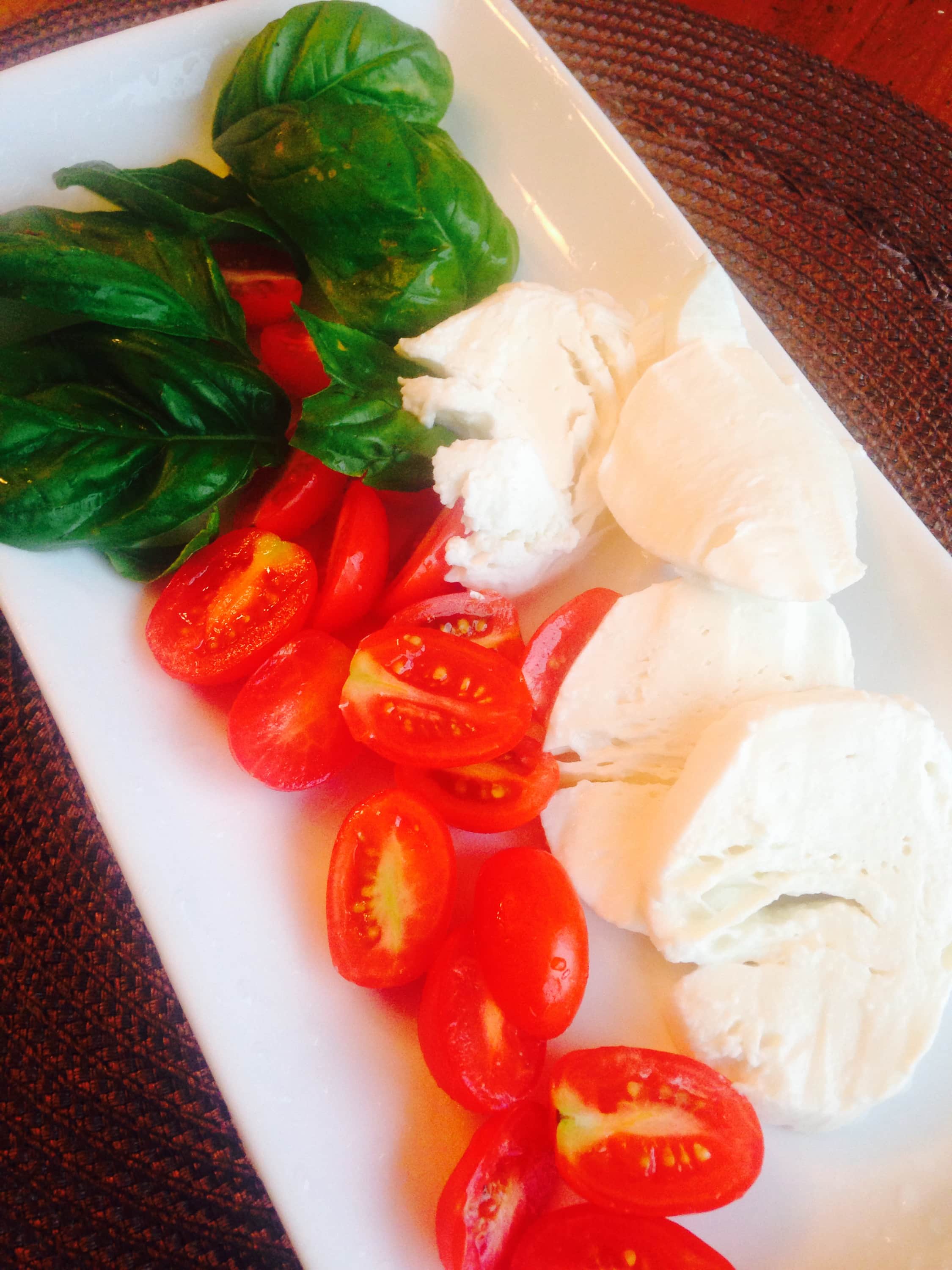 Fresh tomatoes, basil, and mozzarella cheese, used to make easy caprese chicken - a 21 Day Fix recipe.