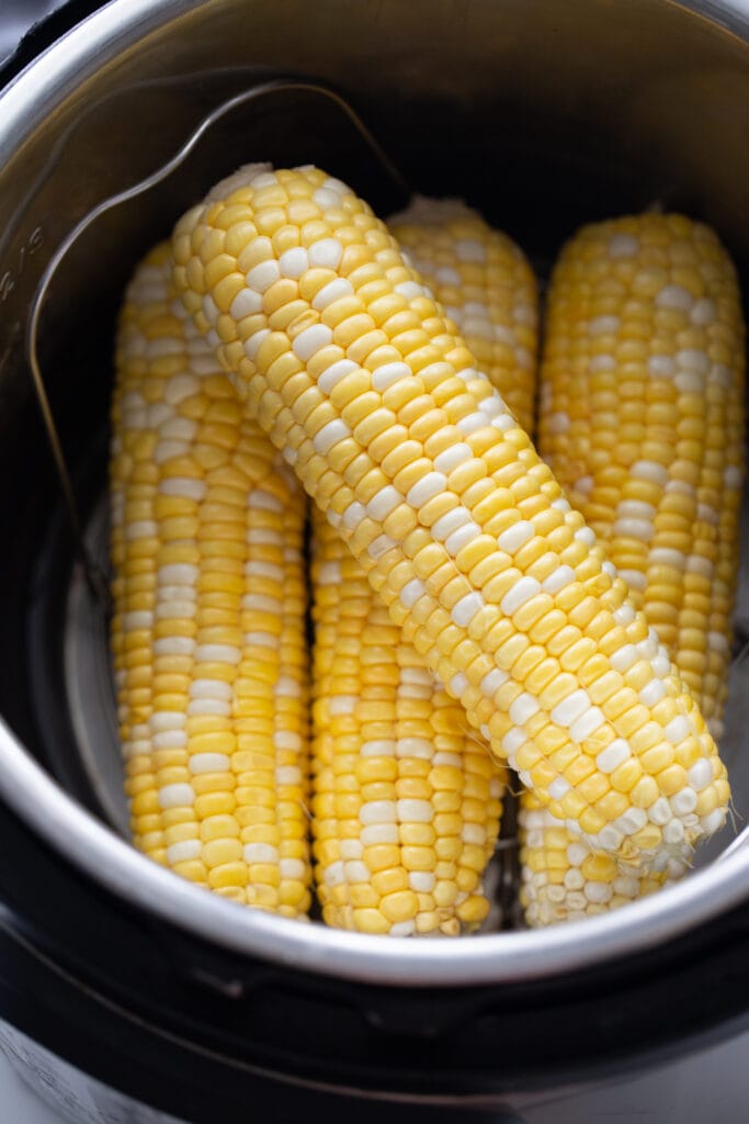Overhead image: Corn on the cob in the instant pot, ready to be cooked