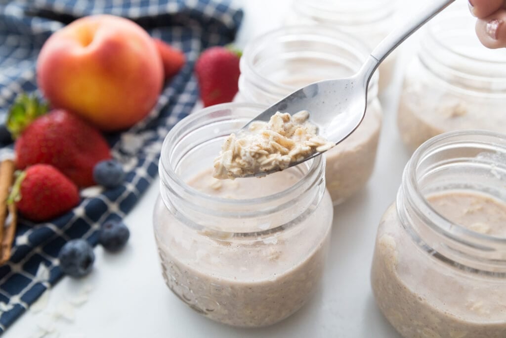 Overnight Oats being divided into mason jars 
