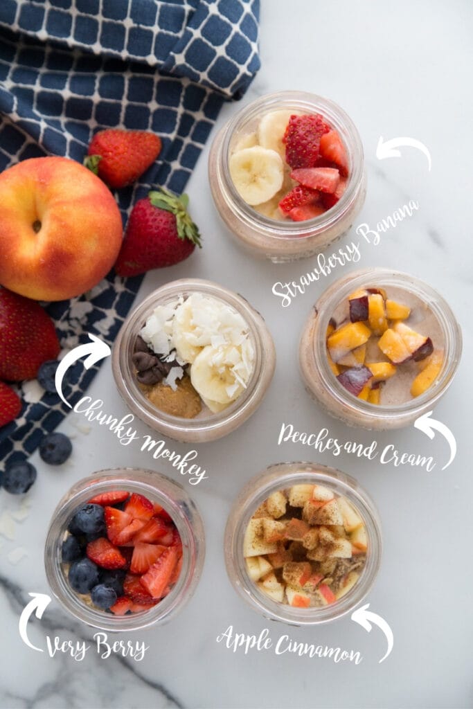 Overnight oats labeled with different flavors- chunky monkey, strawberry banana, peaches and cream, apple cinnamon, and very berry