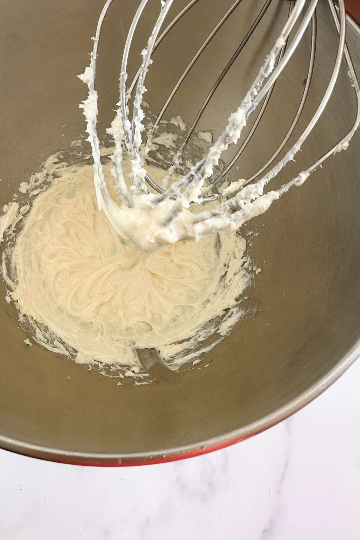 Sweet cream cheese filling in a stand mixer.