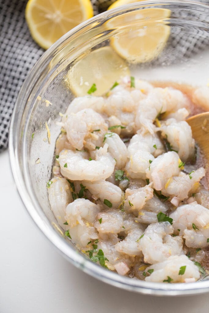 marinated raw shrimp in large glass mixing bowl