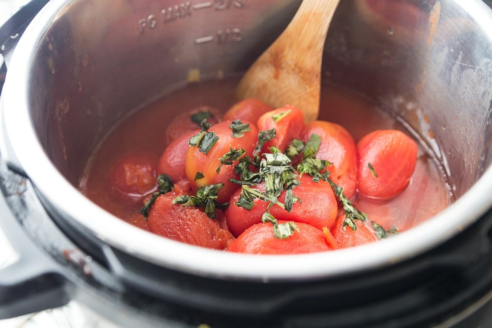 Instant Pot with whole San Marzano Plum Tomatoes and fresh basil 