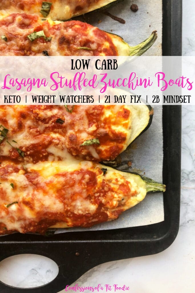 Baking sheet with Lasagna Stuffed Zucchini Boats on a marble backdrop. Boats have been broiled and the cheese is bubbly and crispy. Has the text overlay- Low carb Lasagna Stuffed Zucchini Boats - Keto | Weight Watchers | 21 Day Fix | 2B Mindset - Confessions of a Fit Foodie